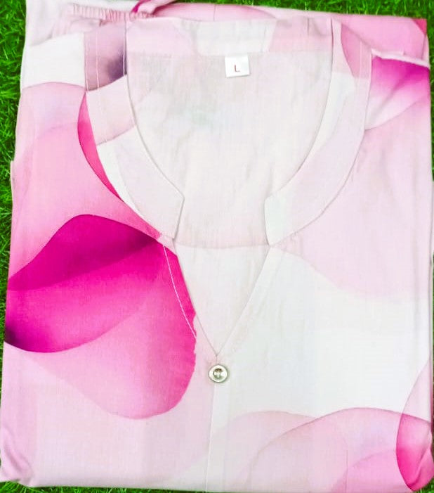 White shirt with pink floral pattern on a grass background