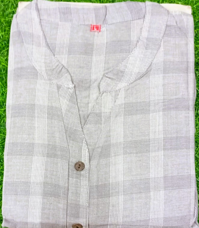 Folded checkered shirt on a grassy background
