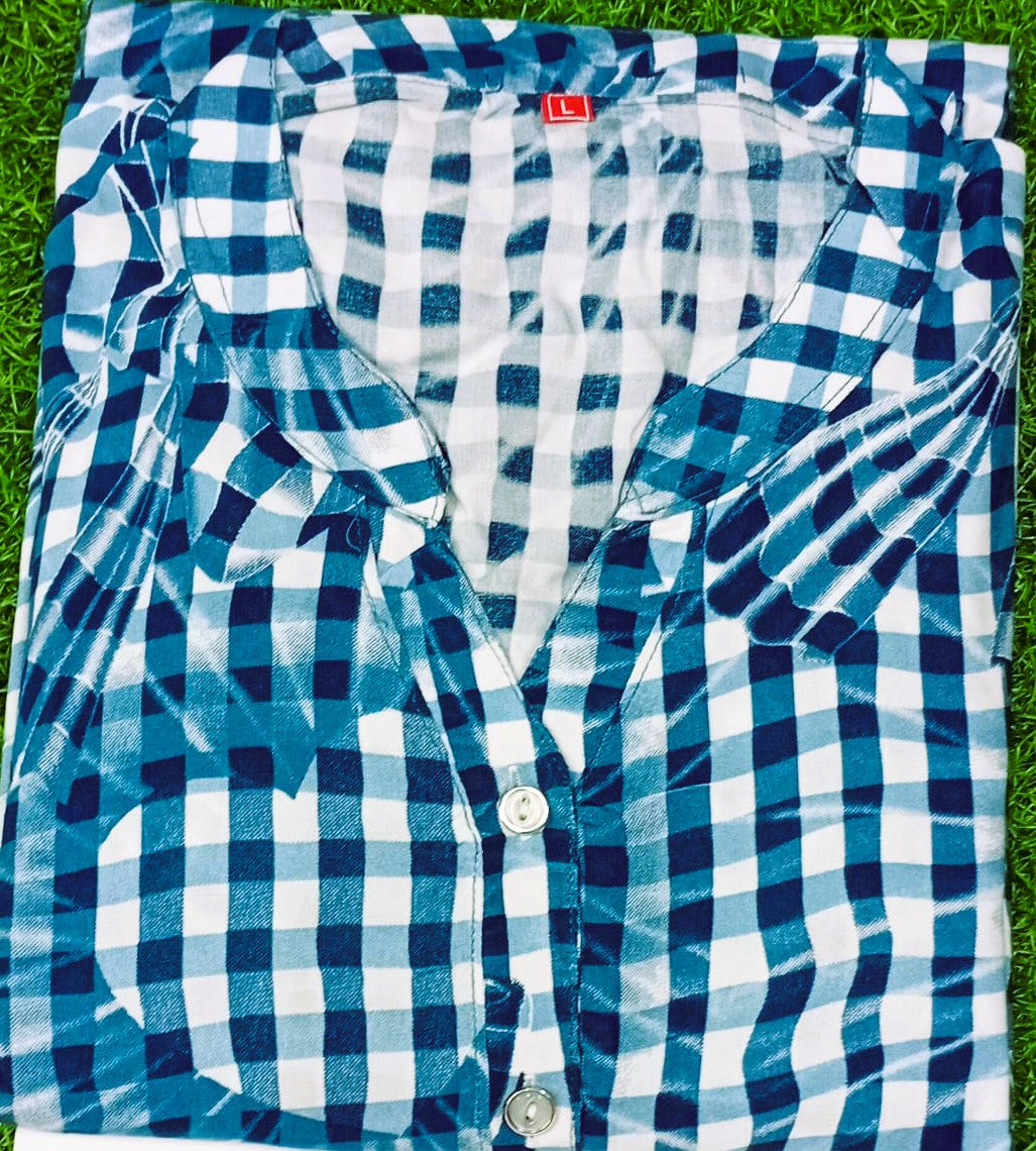 Blue and white checkered shirt on a grassy background