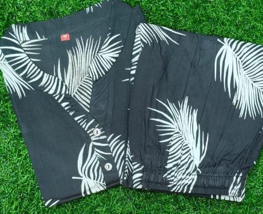 Black shorts with white leaf pattern on grass