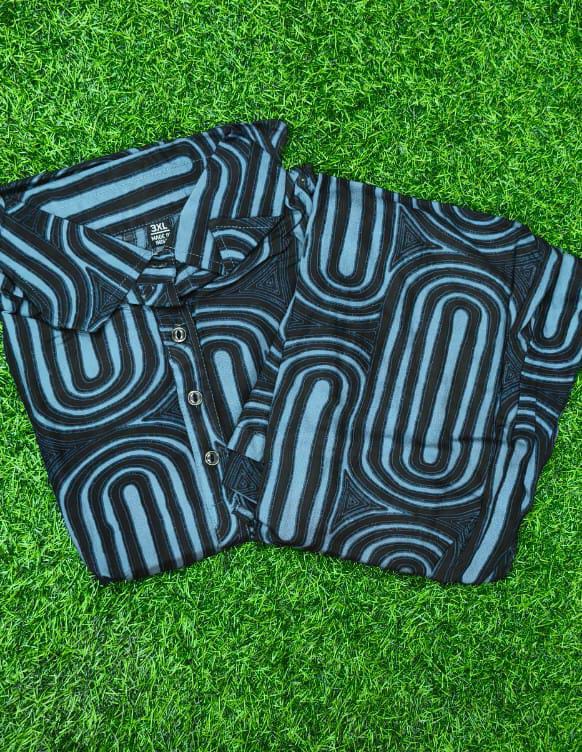 Black and blue patterned shirt on a grass background