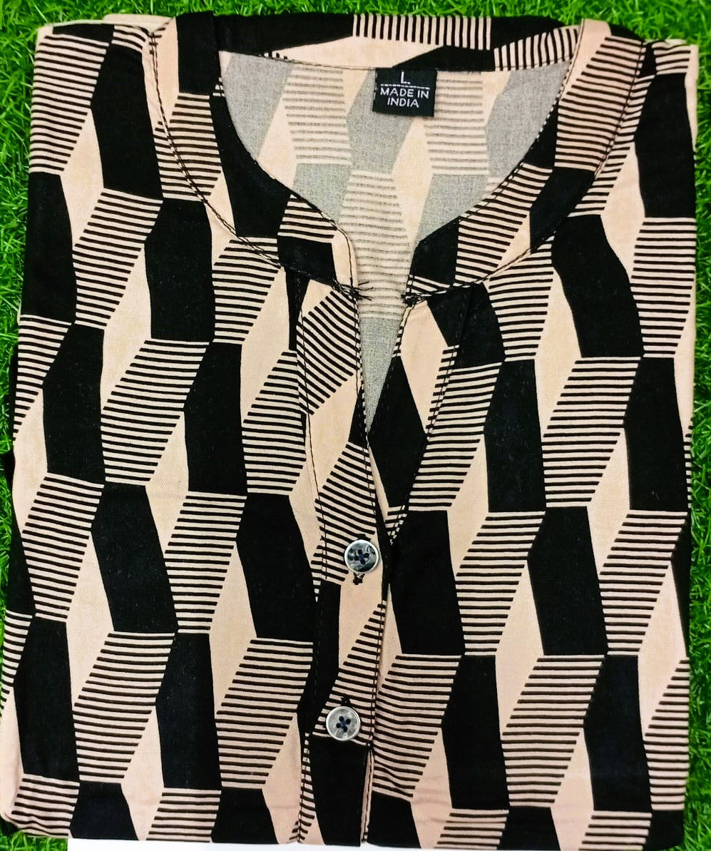 Black and white geometric patterned shirt on a grass background