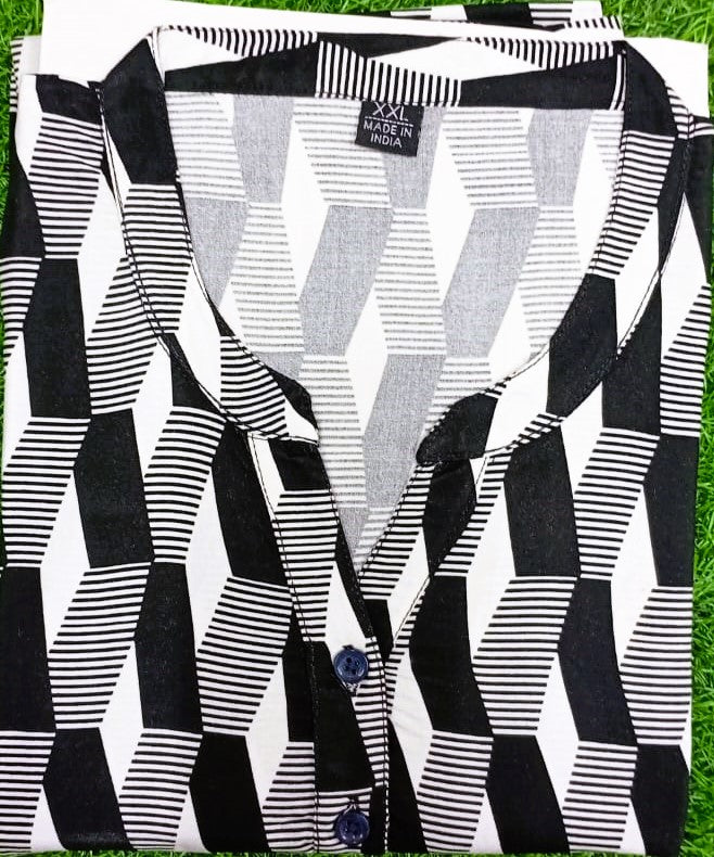 Black and white patterned fabric with a visible brand label on a grass background