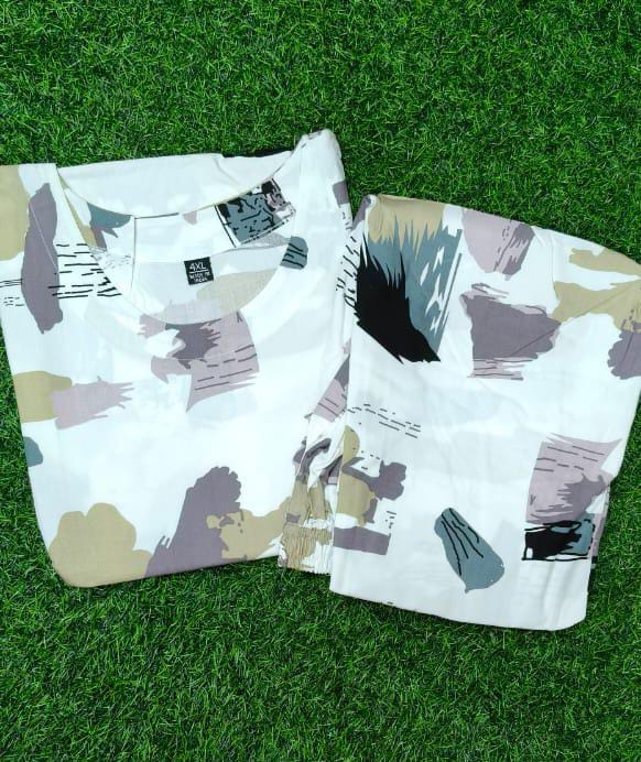 Two patterned shirts on a grass background