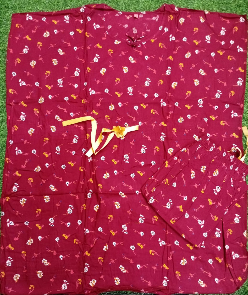Red fabric with small white and yellow patterns on a green surface