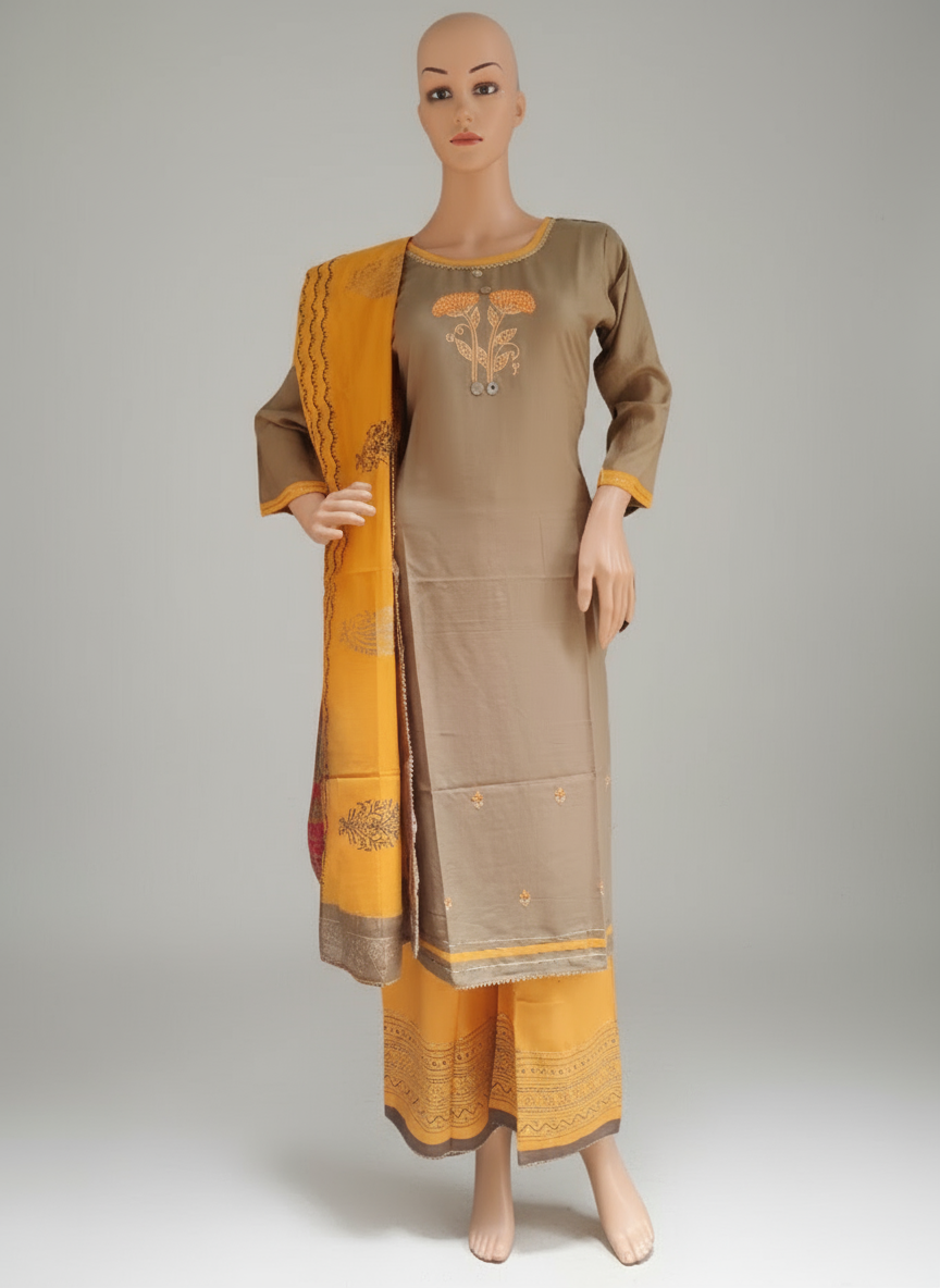 A mannequin displaying a beige and orange embroidery kurta with palazzo and dupatta.