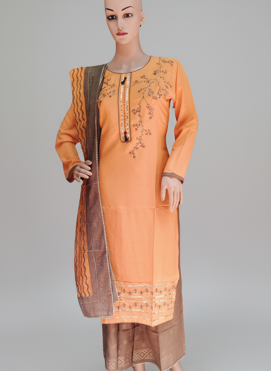 A mannequin displaying a female kurta set with embroidery and gold foil print, consisting of a kurta, palazzo pants, and a dupatta in orange and brown colors.
