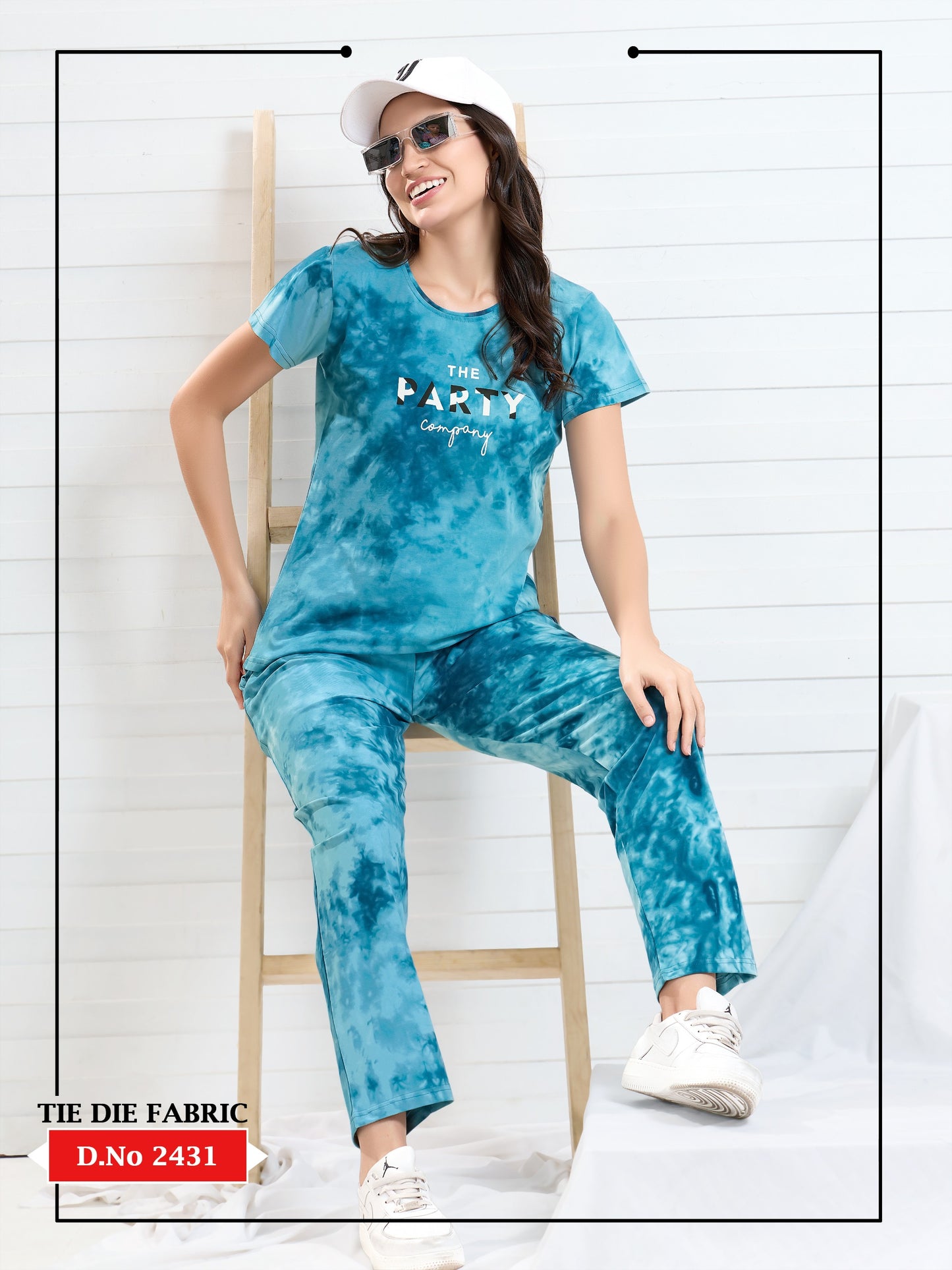 Woman wearing a blue tie-dye outfit with 'The Party' design on a white background