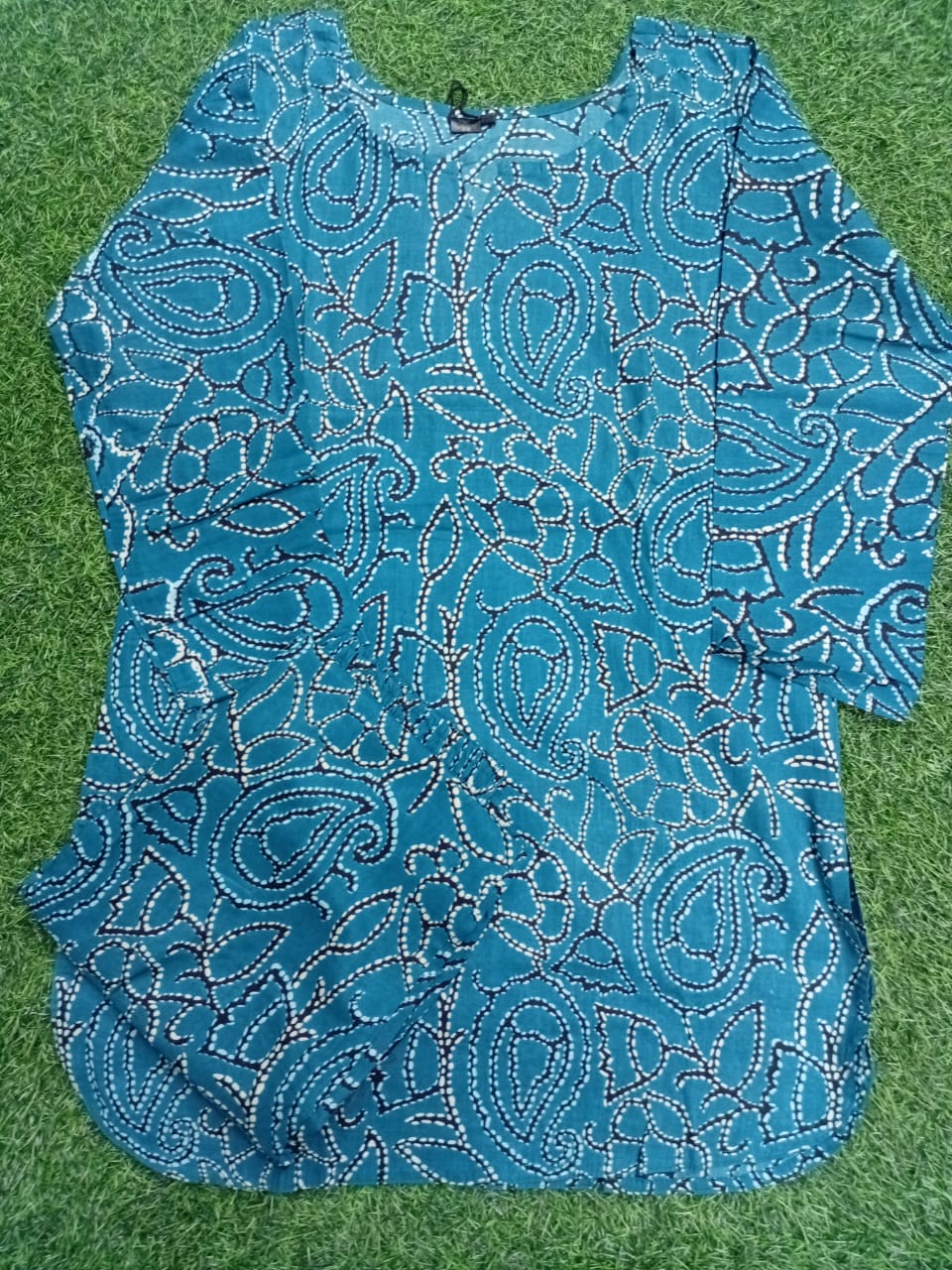 Blue lace top on a green grass background