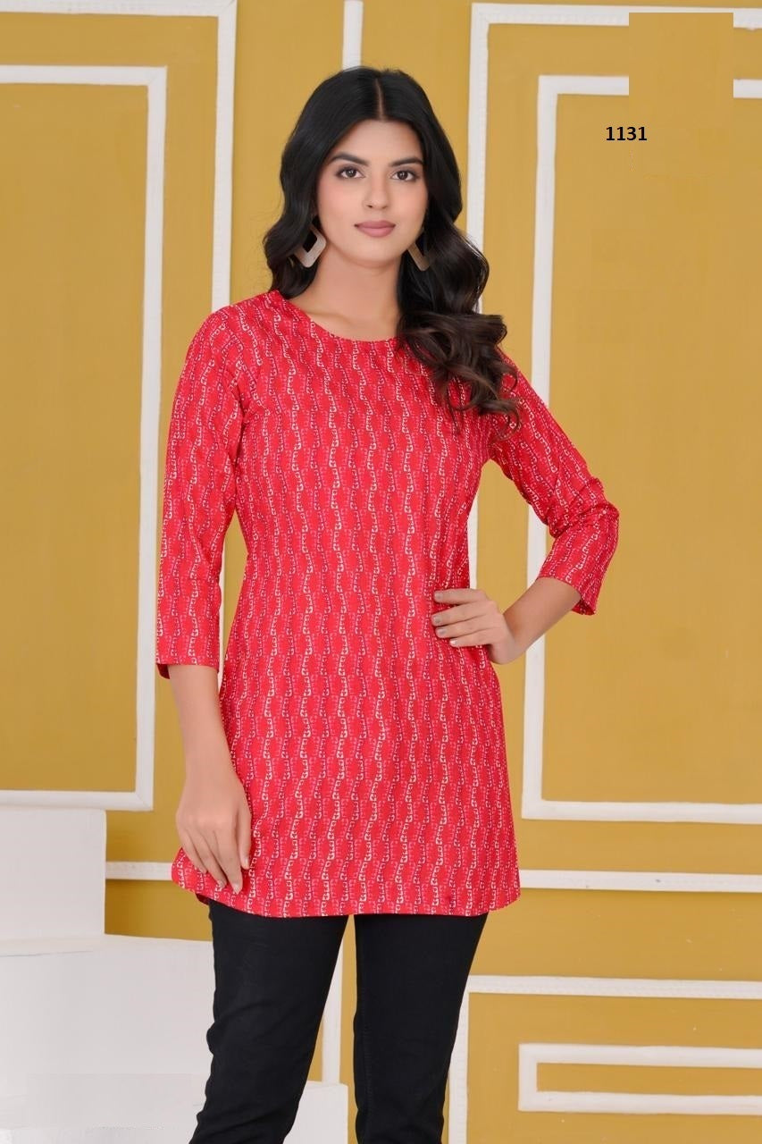 Woman wearing a red patterned kurta with black pants against a yellow geometric background