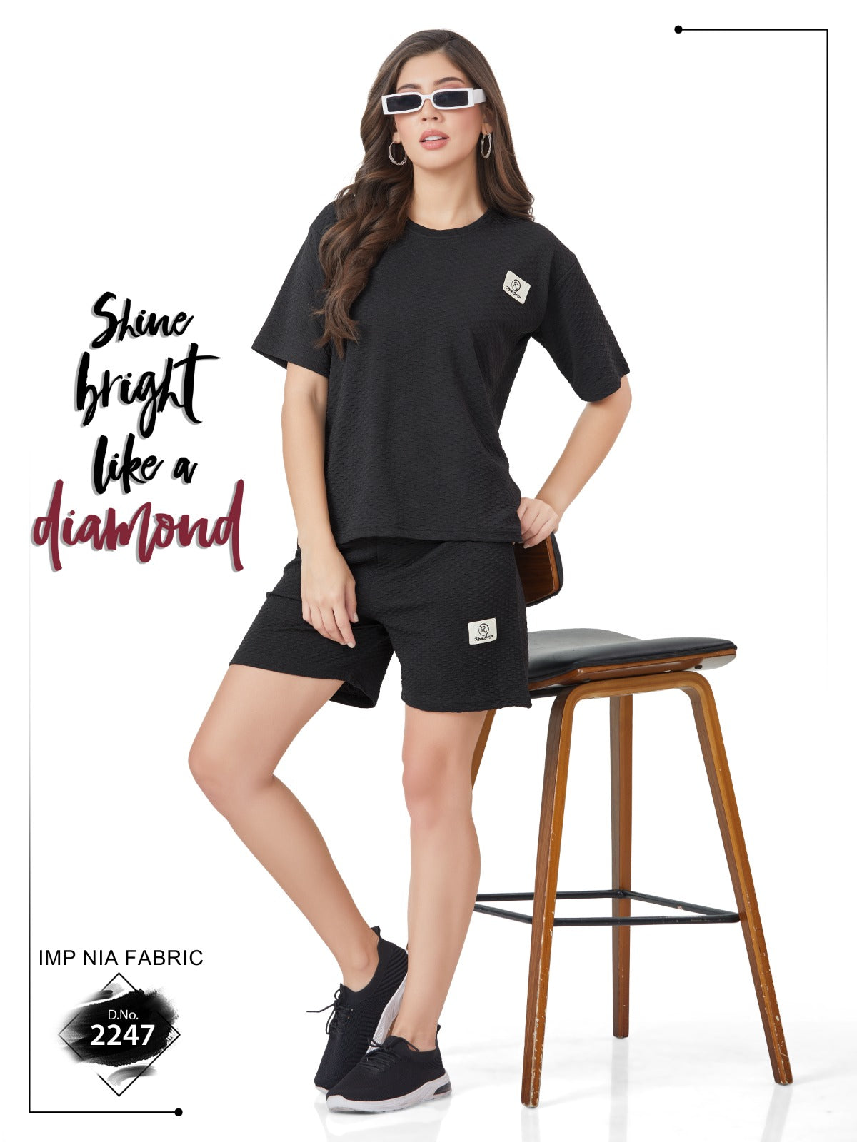 A girl wearing a black t-shirt and shorts sitting on a stool, with the text 'Shine bright like a diamond' and the brand name 'VogPap'.