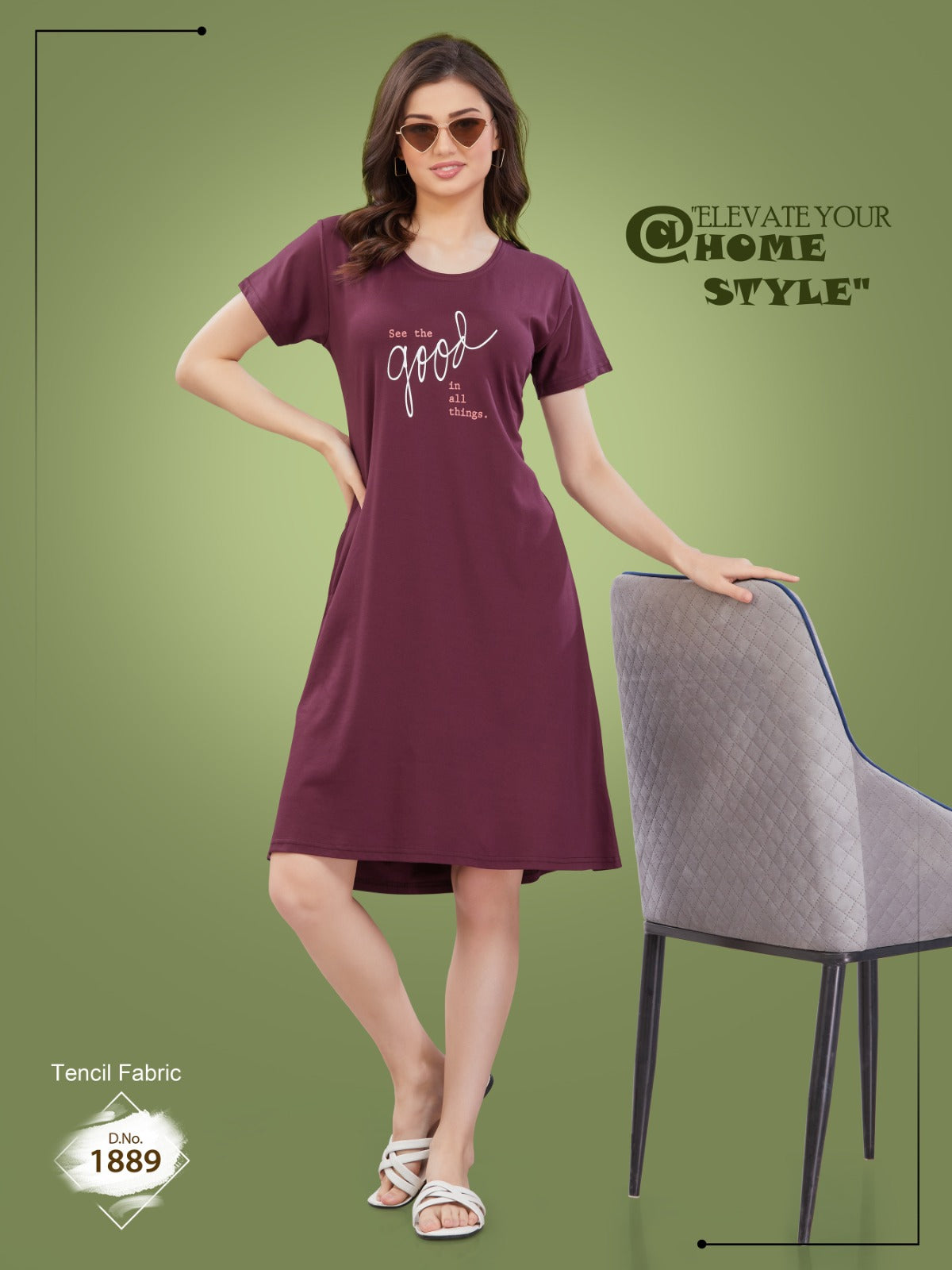 A woman standing next to a chair, wearing a maroon nightdress with short sleeves and a round neckline.