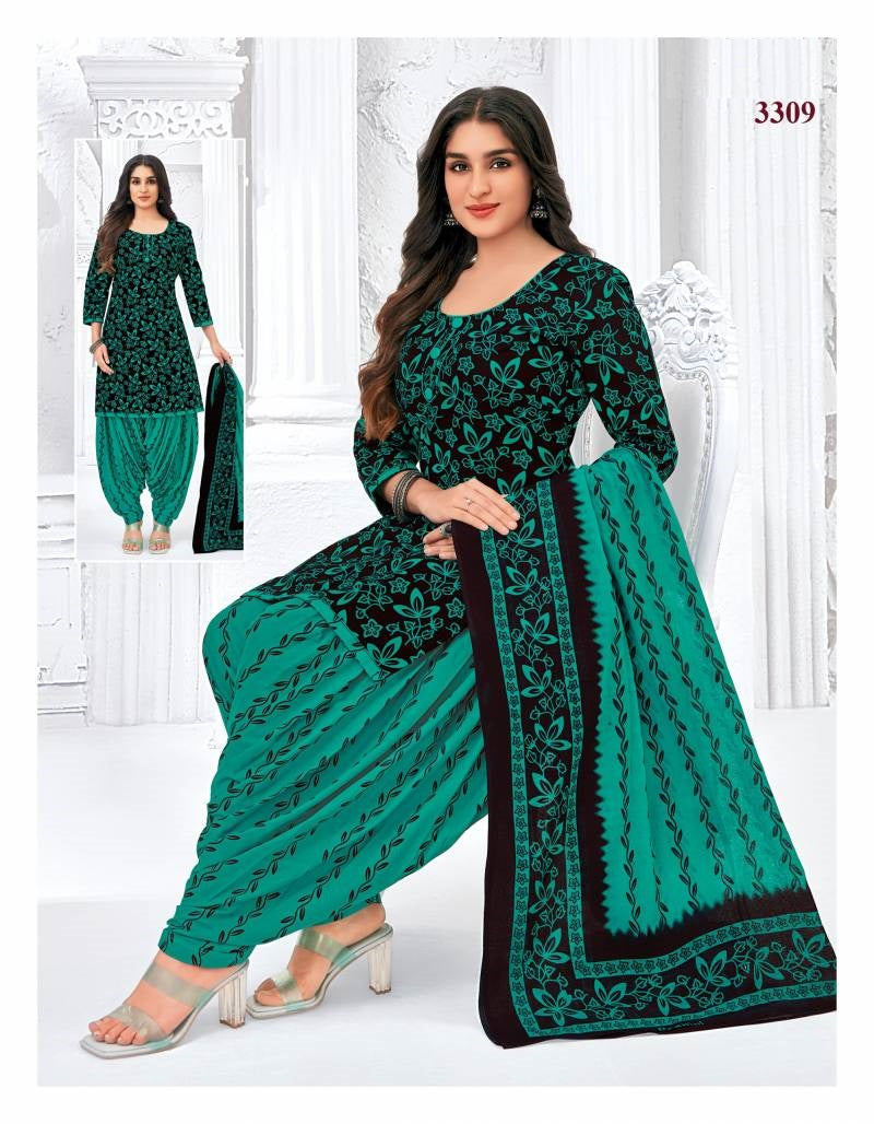 Woman wearing a green and black traditional outfit with a matching dupatta, standing against a white background.