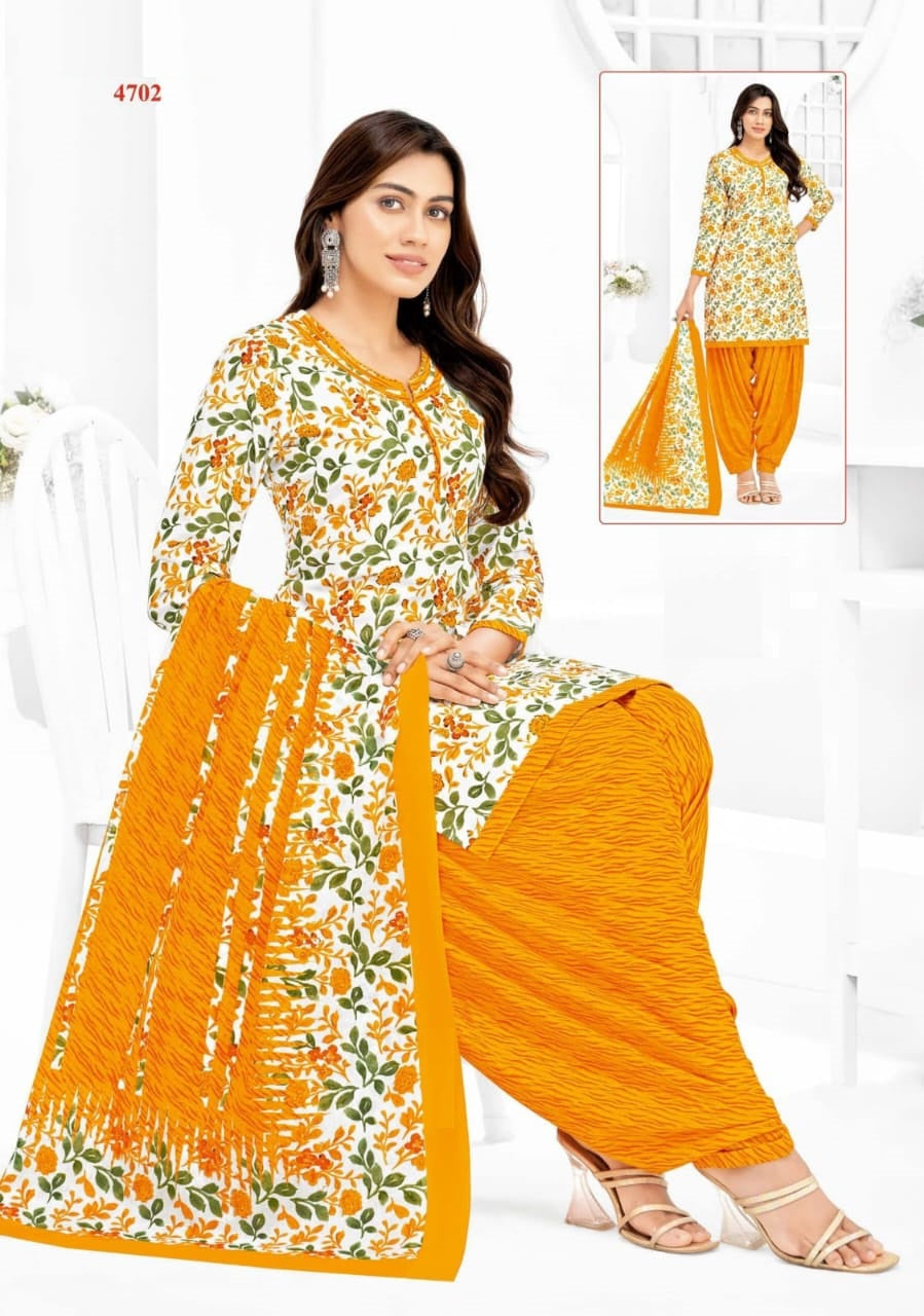 Woman wearing a traditional outfit with floral patterns and orange dupatta on a white background