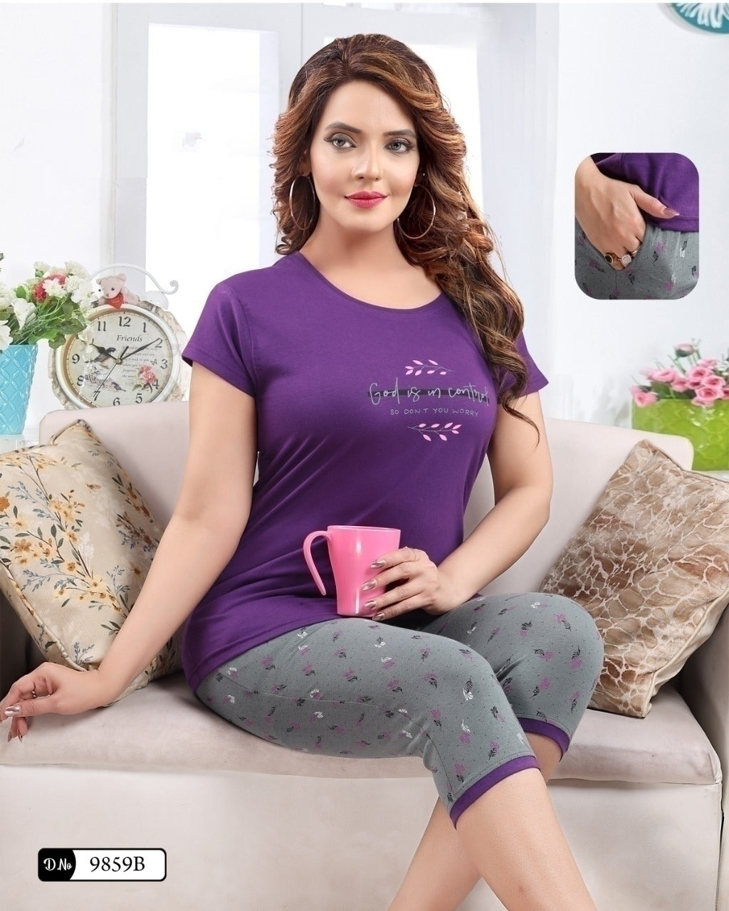 A woman sitting on a sofa, wearing a purple capri nightsuit with a round neckline and short sleeves, holding a pink cup.