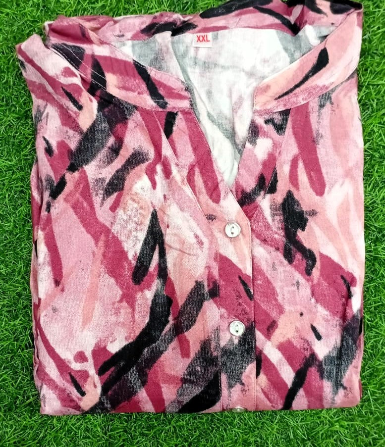 Pink camouflage shirt with black patterns on a grass background