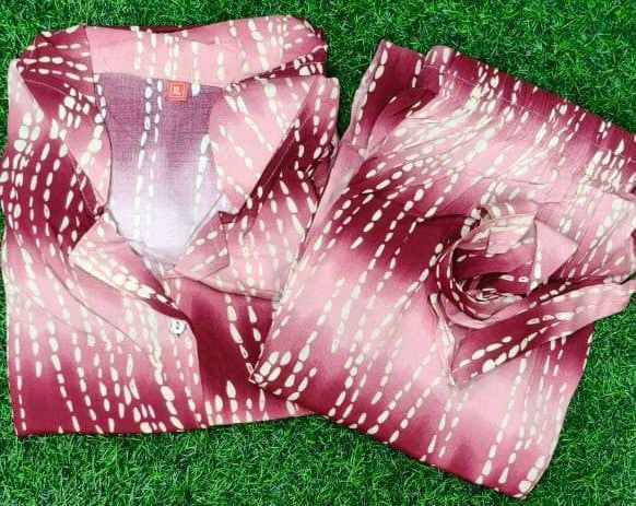 Two patterned scarves on a grassy background
