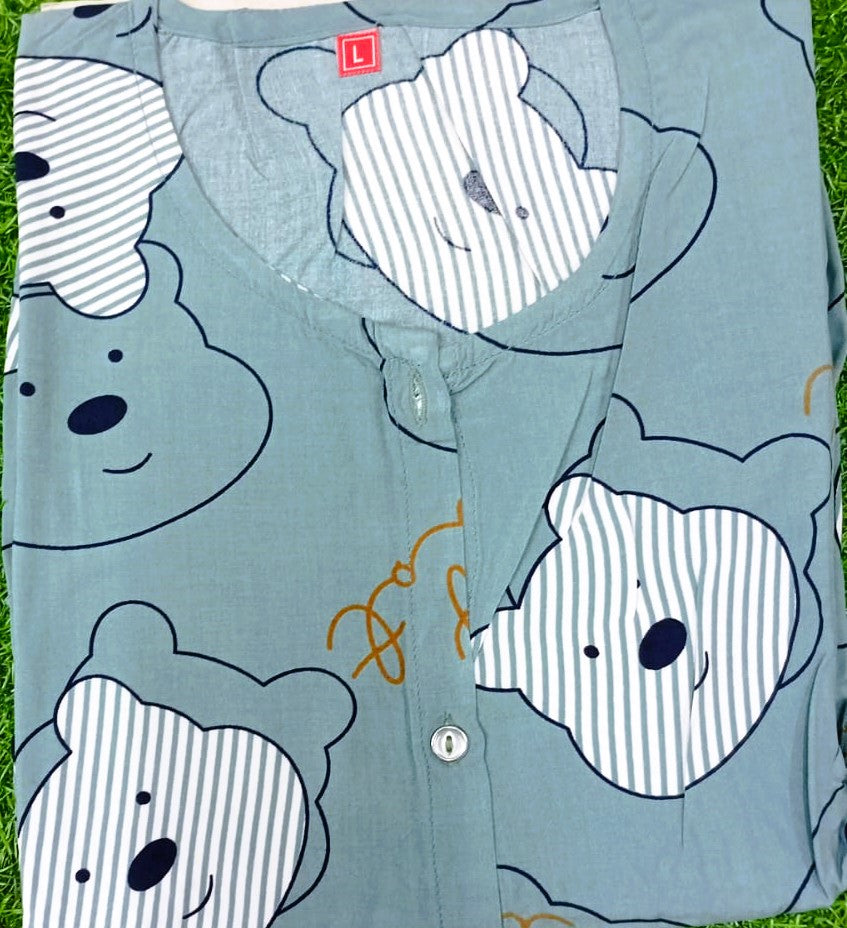 Light blue shirt with bear face patterns on a grass background