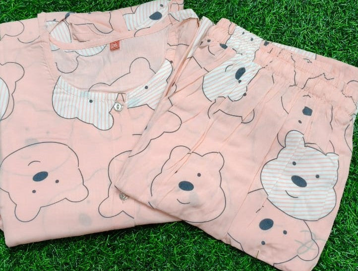 Pink pajama set with bear pattern on a grass background