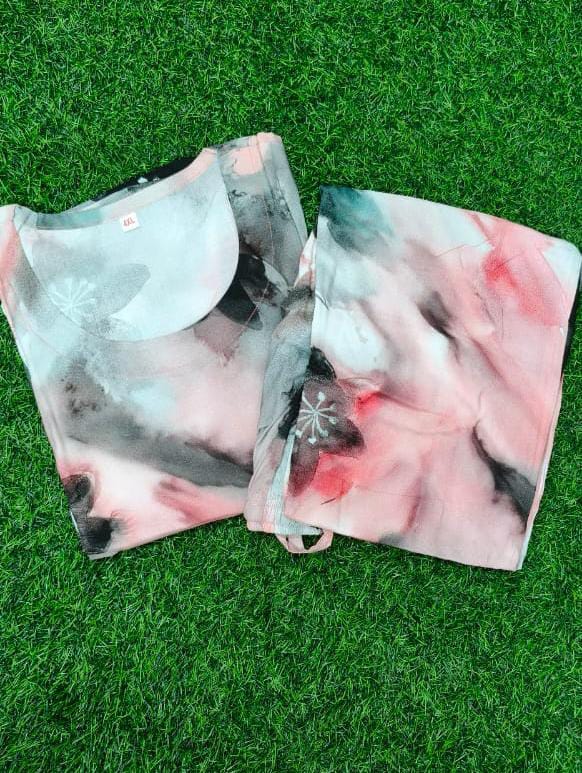 Two floral-patterned face masks on a grass background