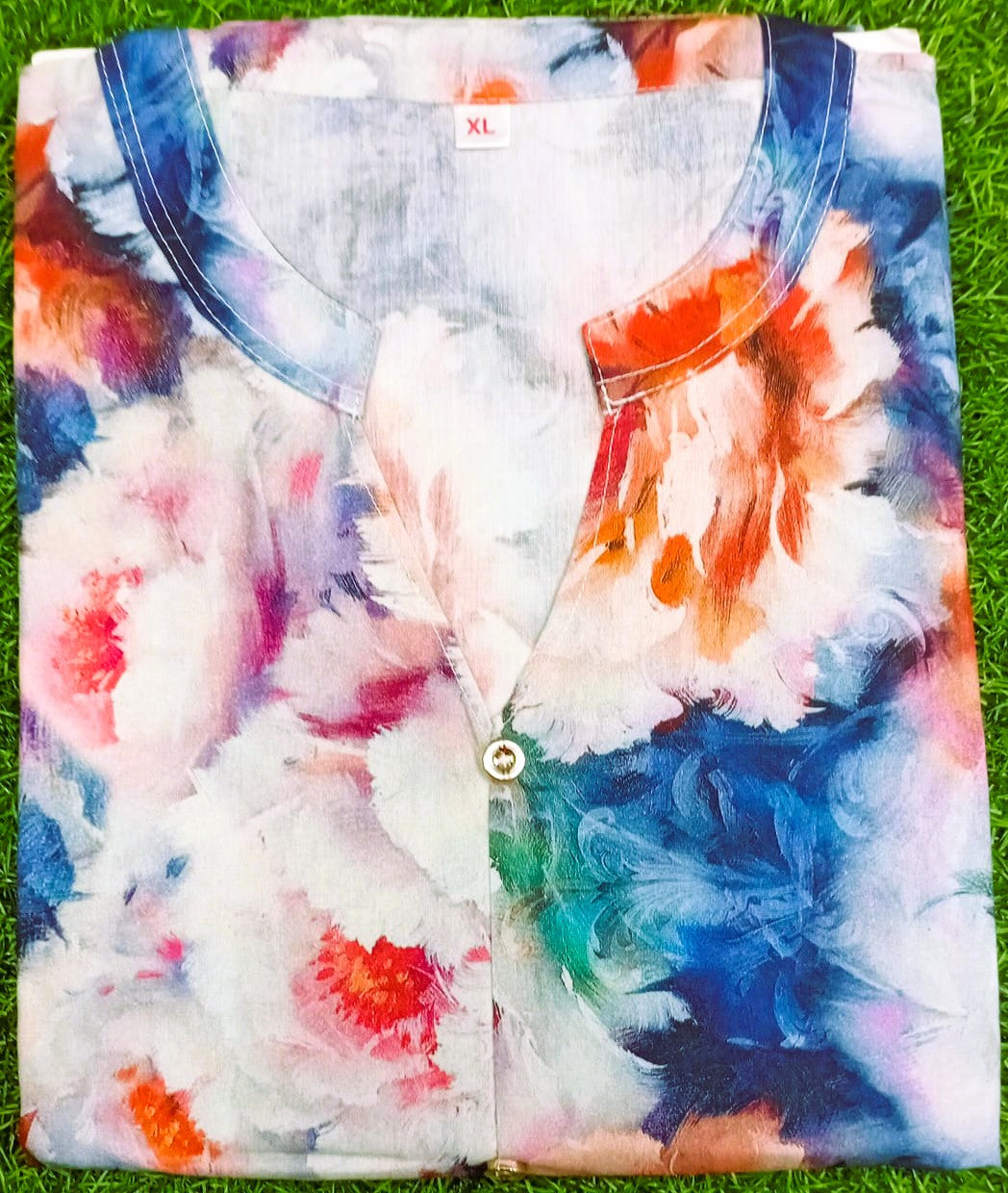 Colorful floral-patterned shirt on a grass background