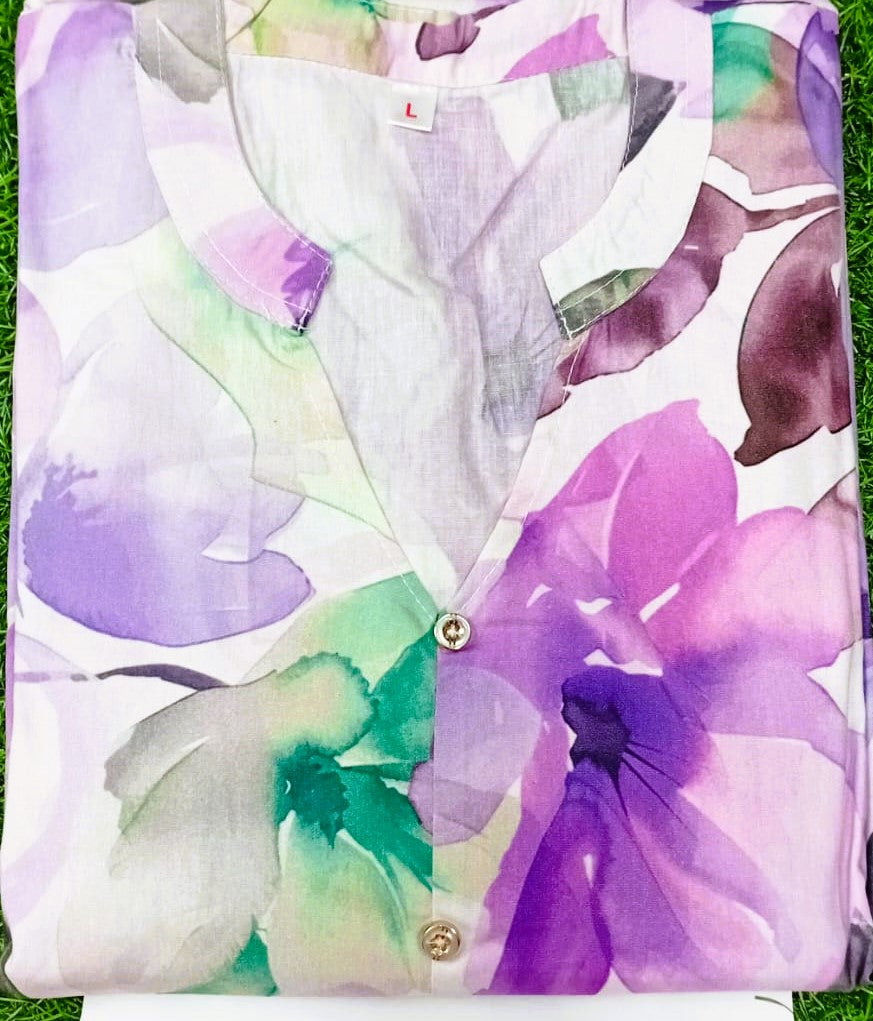 Floral-patterned shirt with purple and green flowers on a grass background
