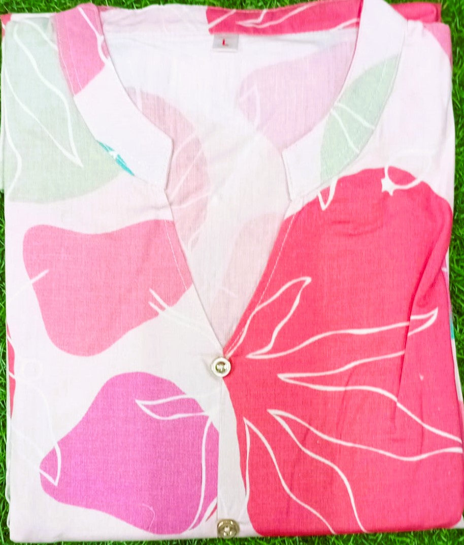 Pink and white floral patterned fabric on a grass background