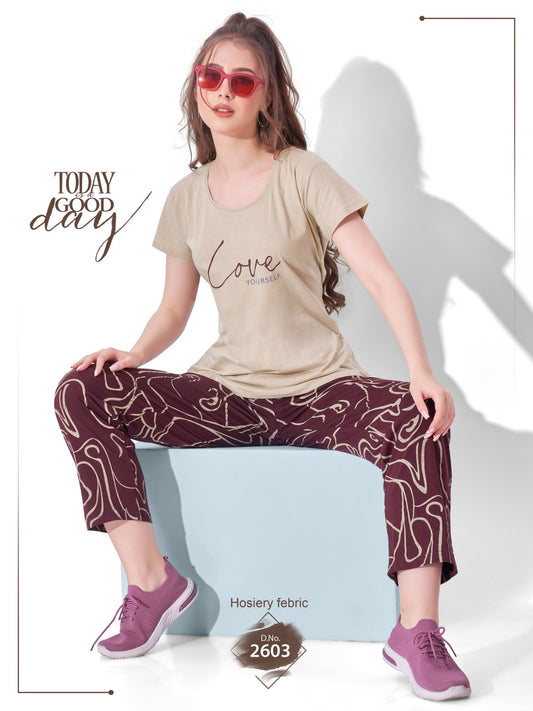 Woman wearing a beige t-shirt and patterned pants sitting on a white stool with 'Today Good Day' text.