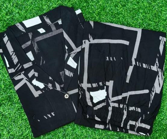 Black and white patterned jacket on a green grass background