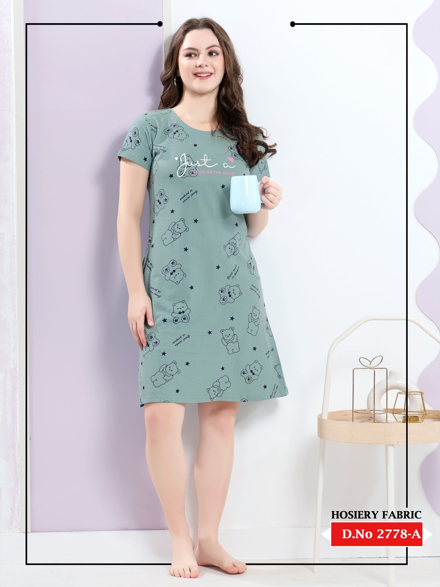 Woman wearing a green nightshirt with cartoon designs against a white background