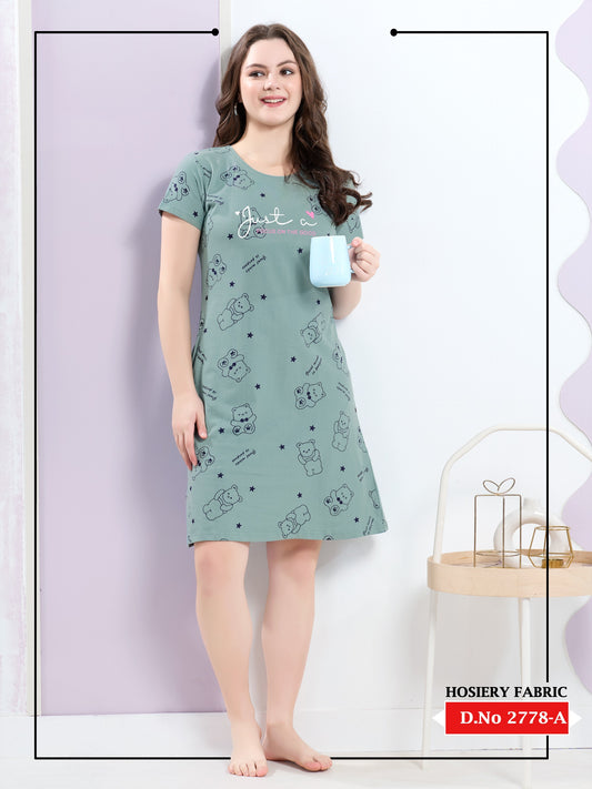 Woman wearing a green nightshirt with cartoon designs against a white background
