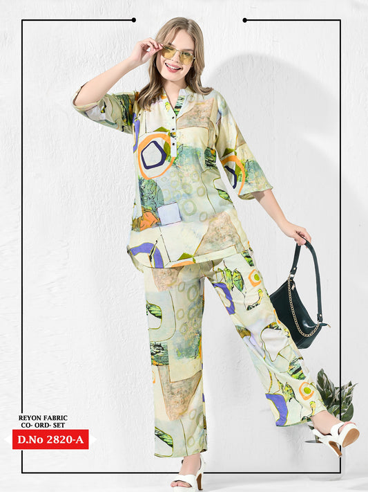 Woman wearing a colorful outfit with a floral pattern, holding a black handbag on a white background.