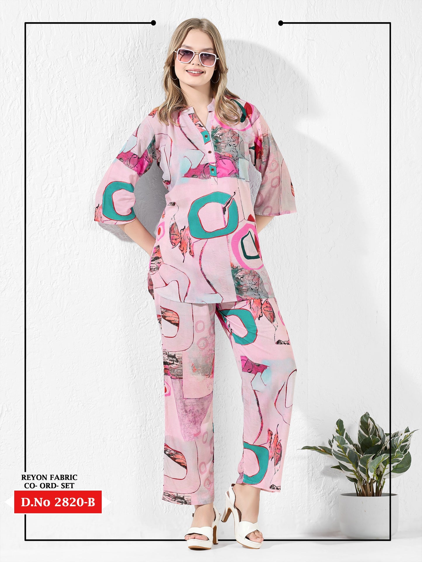 Woman wearing a pink and teal patterned outfit on a white background