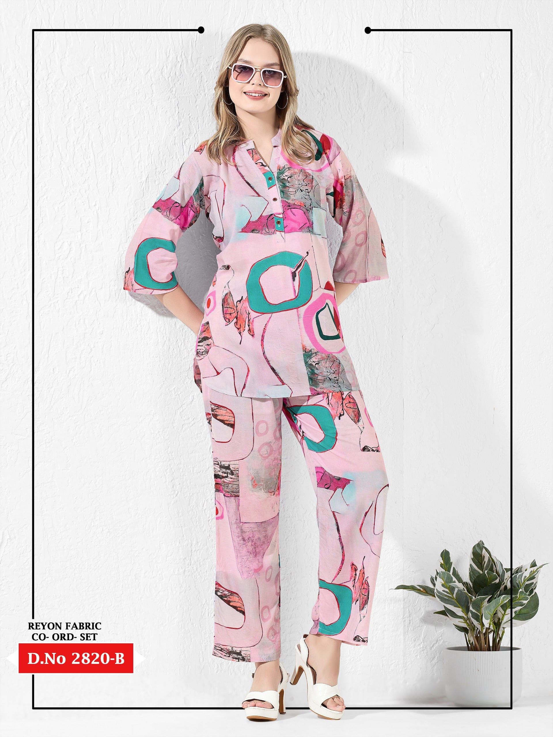 Woman wearing a pink and teal patterned outfit on a white background