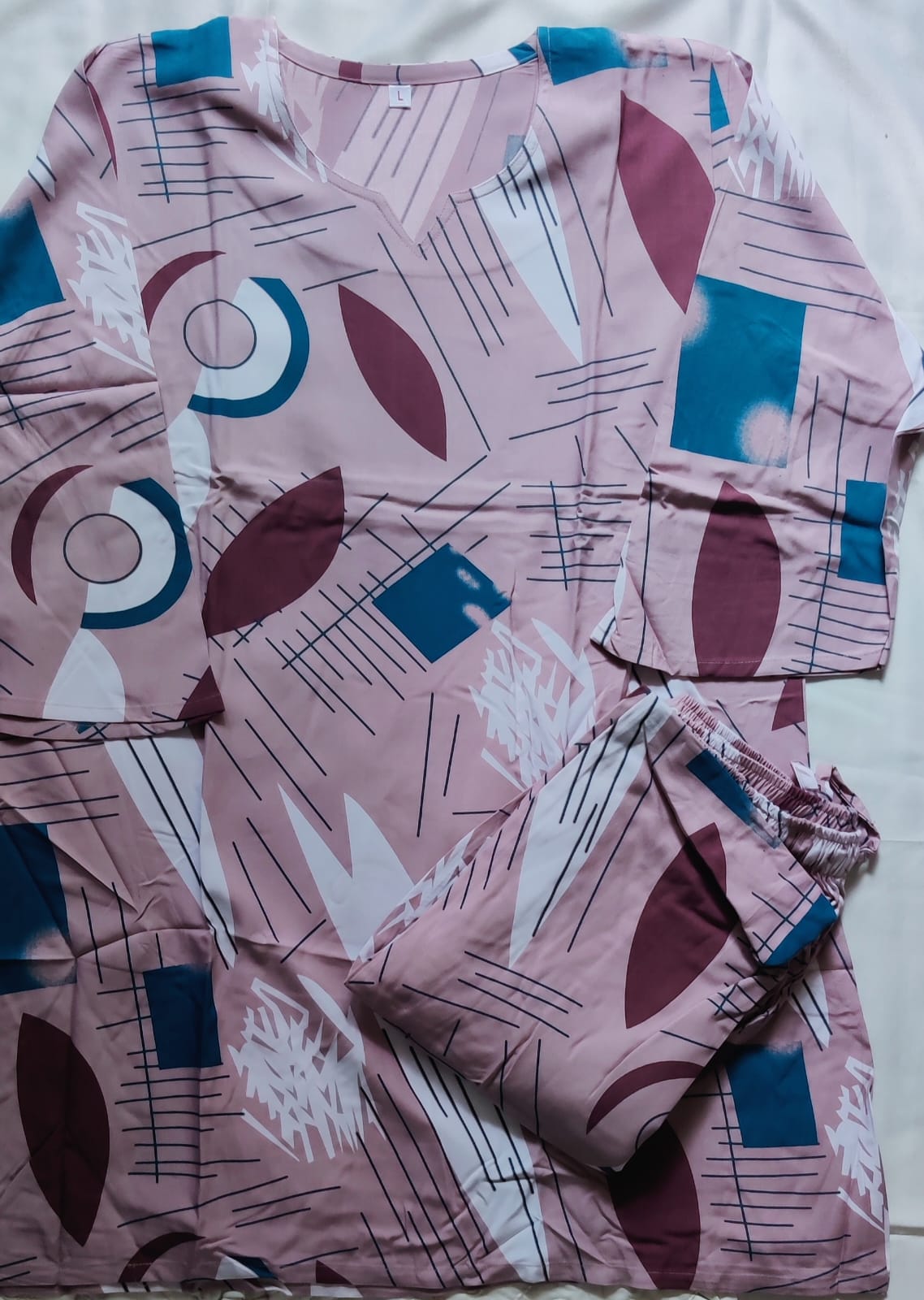 Pink pajama set with geometric pattern on a white background