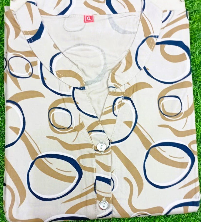 White shirt with blue and brown abstract pattern on grass