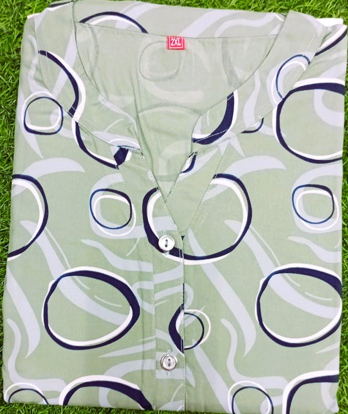 Light green shirt with blue and white abstract pattern on a grass background