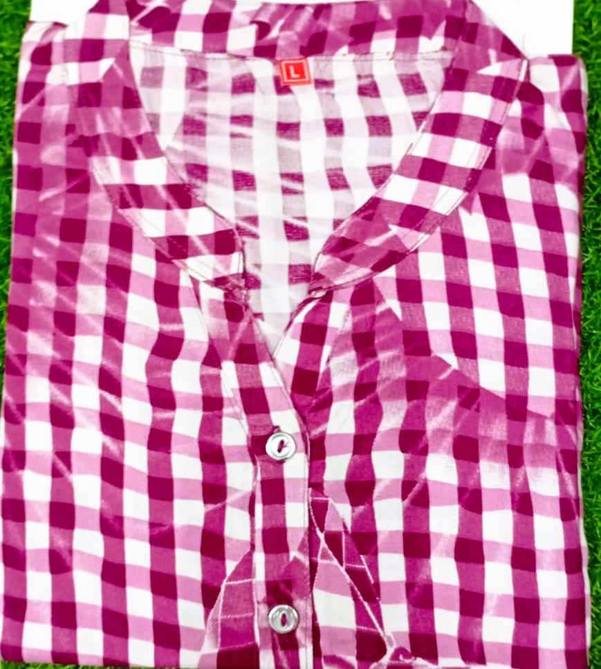 Pink and white checkered shirt on a grassy background