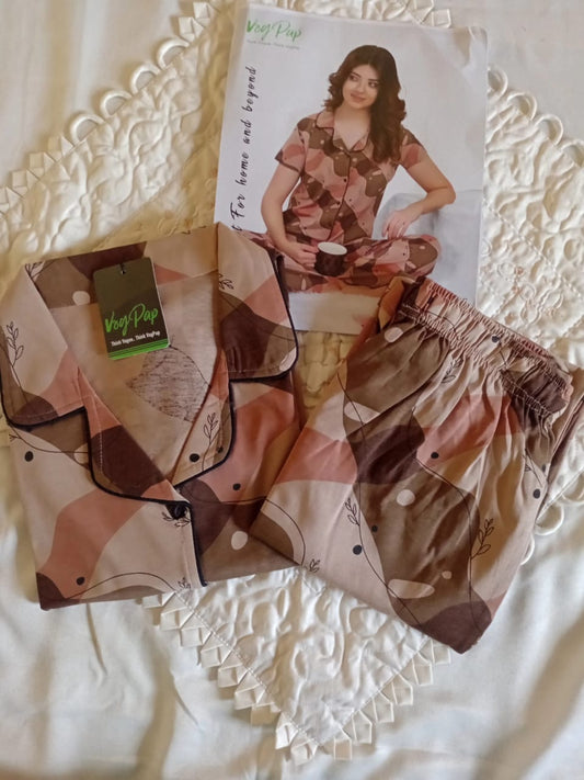 Patterned shorts with a magazine featuring a model wearing similar clothing on a textured surface.