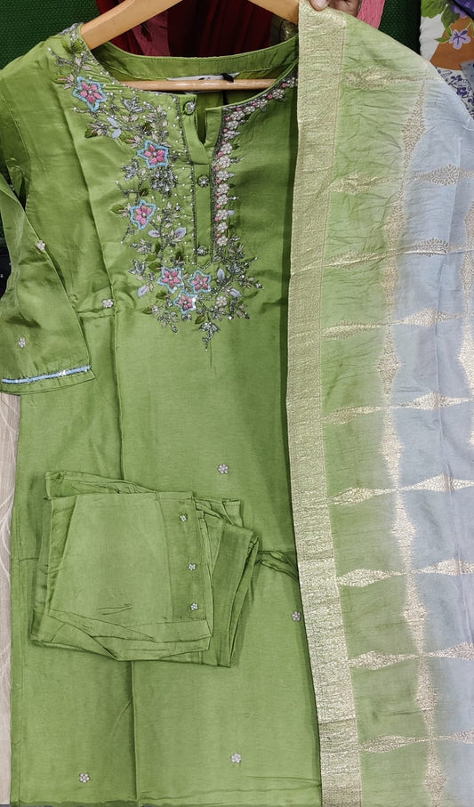 Green embroidered traditional outfit with a plain green dupatta on a hanger.