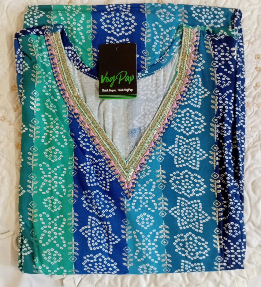 Blue and green patterned garment with a tag on a textured white background