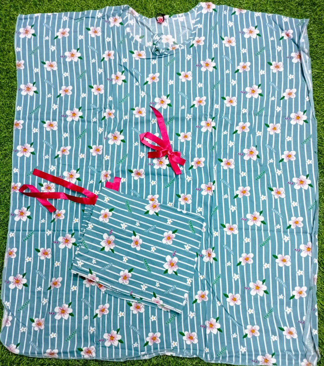 Floral-patterned fabric with pink ribbons on a grass background