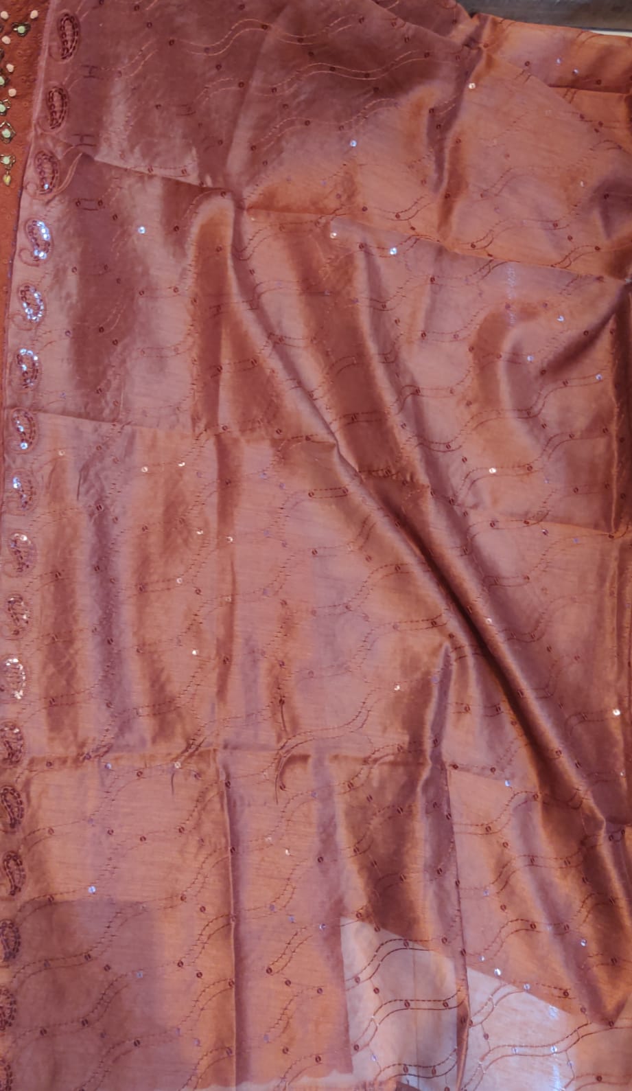 Close-up of pink fabric with bead embellishments