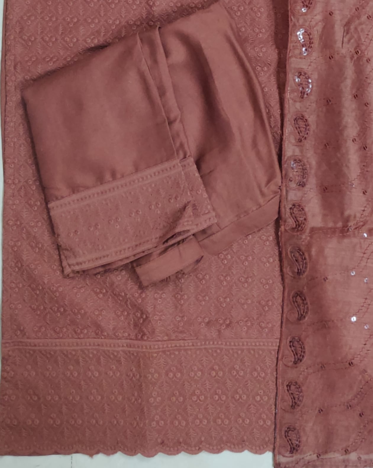 Close-up of a pink embroidered fabric with a pocket