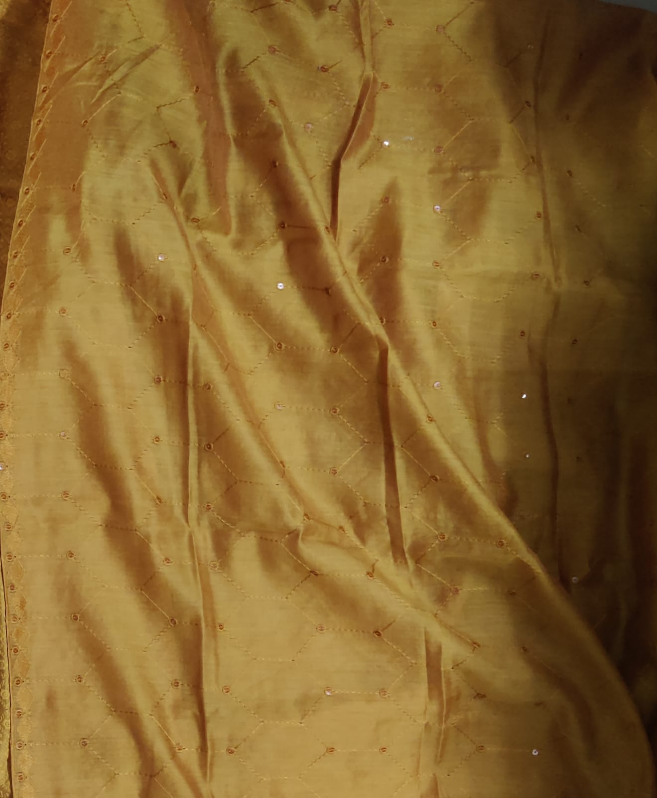 Gold fabric with subtle texture and patterns