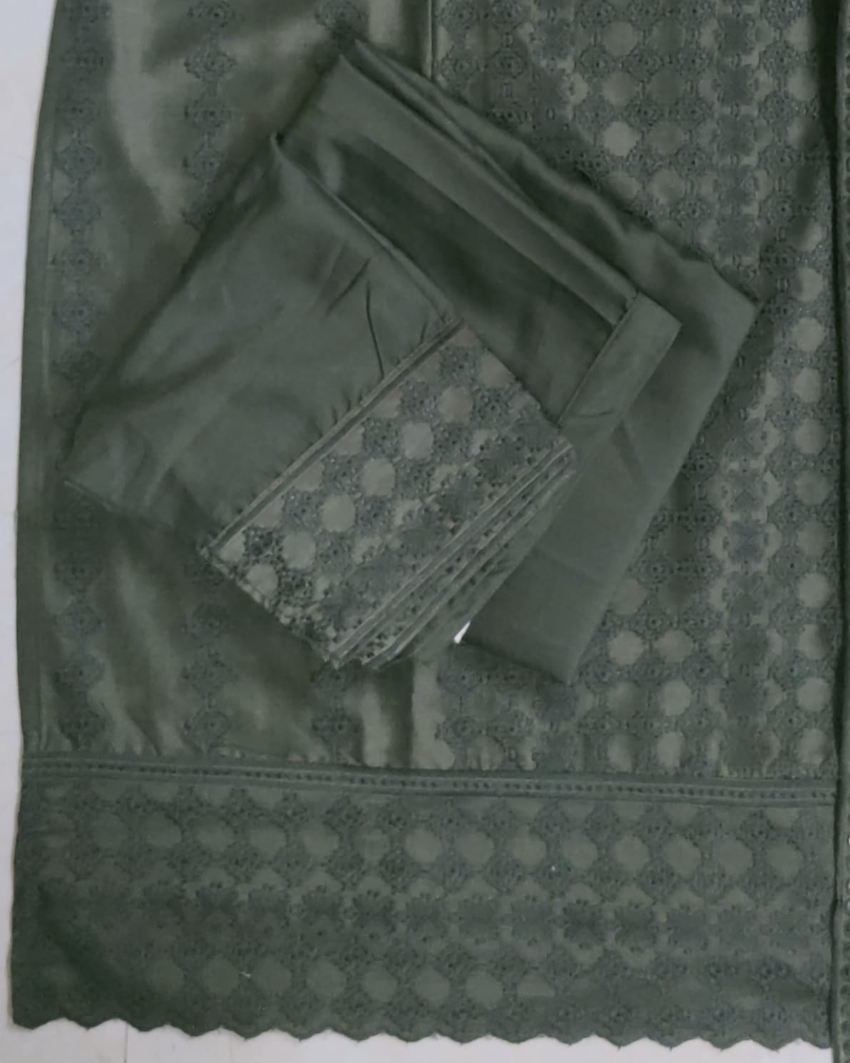 Green fabric with a patterned pocket on a matching green background