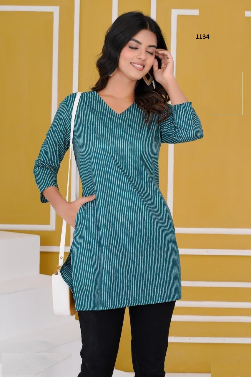 Woman wearing a teal striped dress against a yellow background