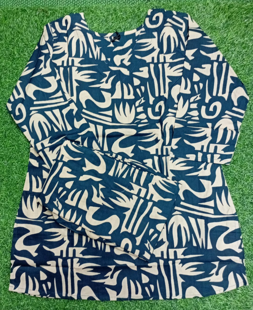 Blue and white patterned dress on a green grass background