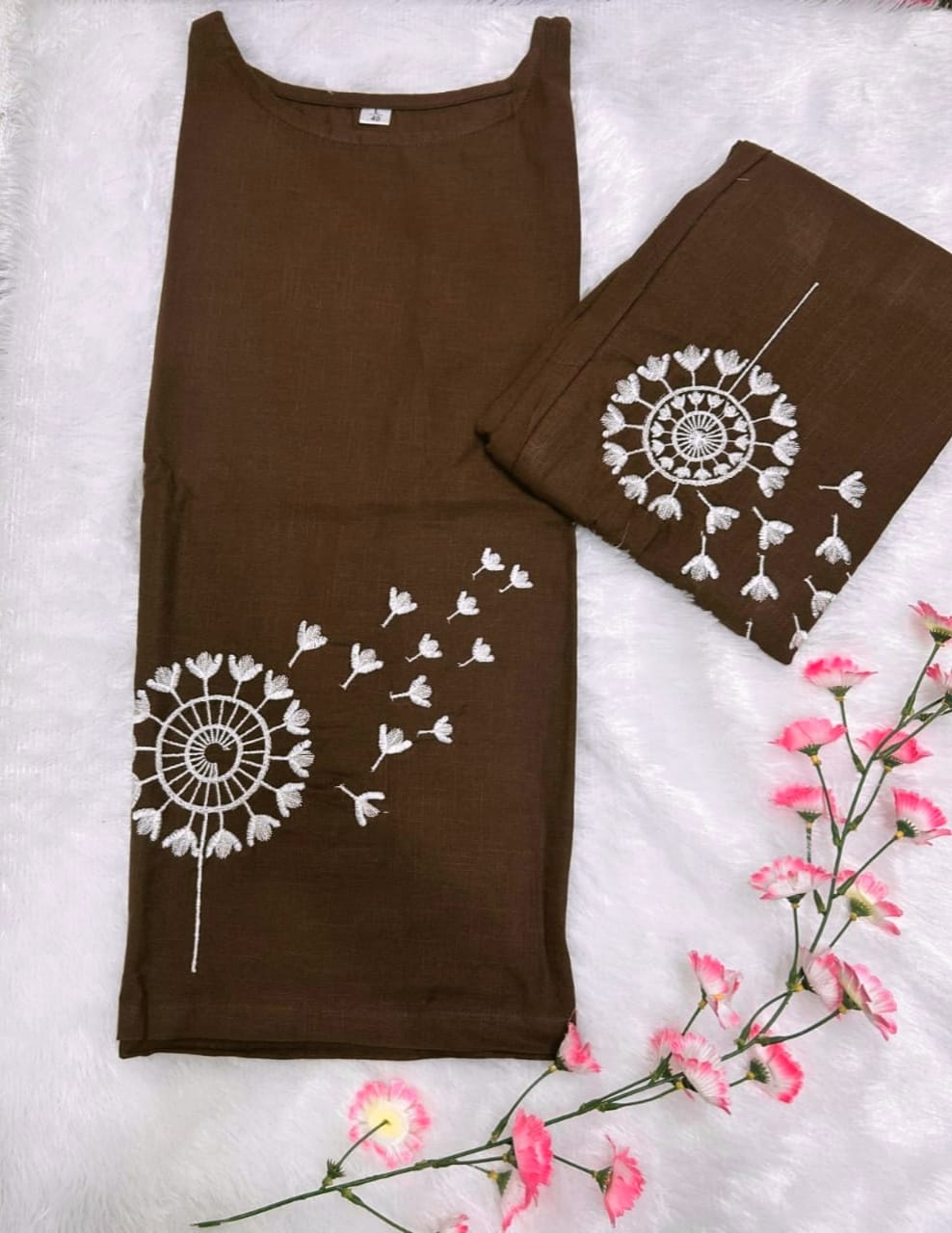 Brown tank top and leggings with white floral designs on a white background with pink flowers.