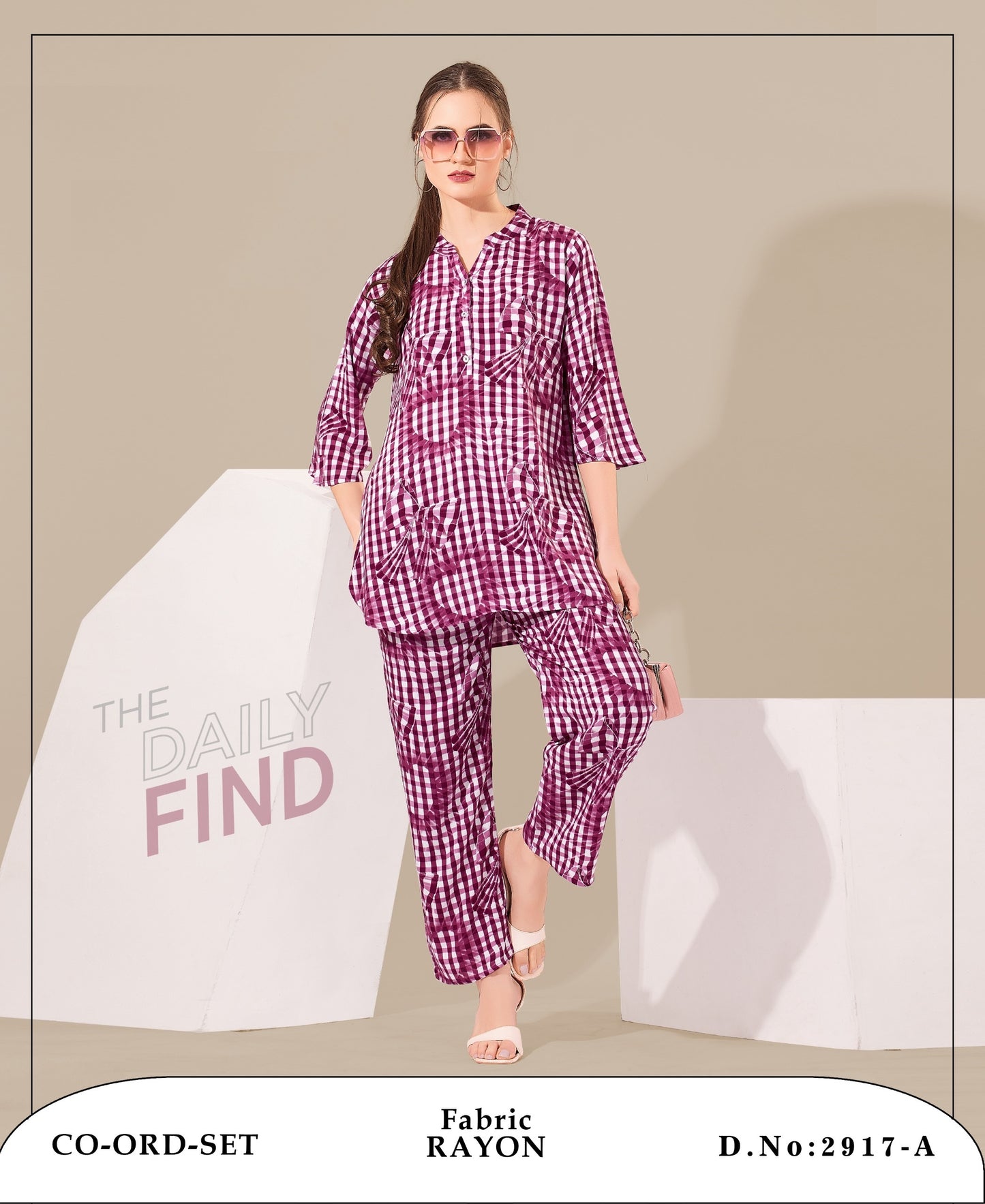 A model wearing a pink and white checkered kurti and sharara bottom, standing against a beige background.